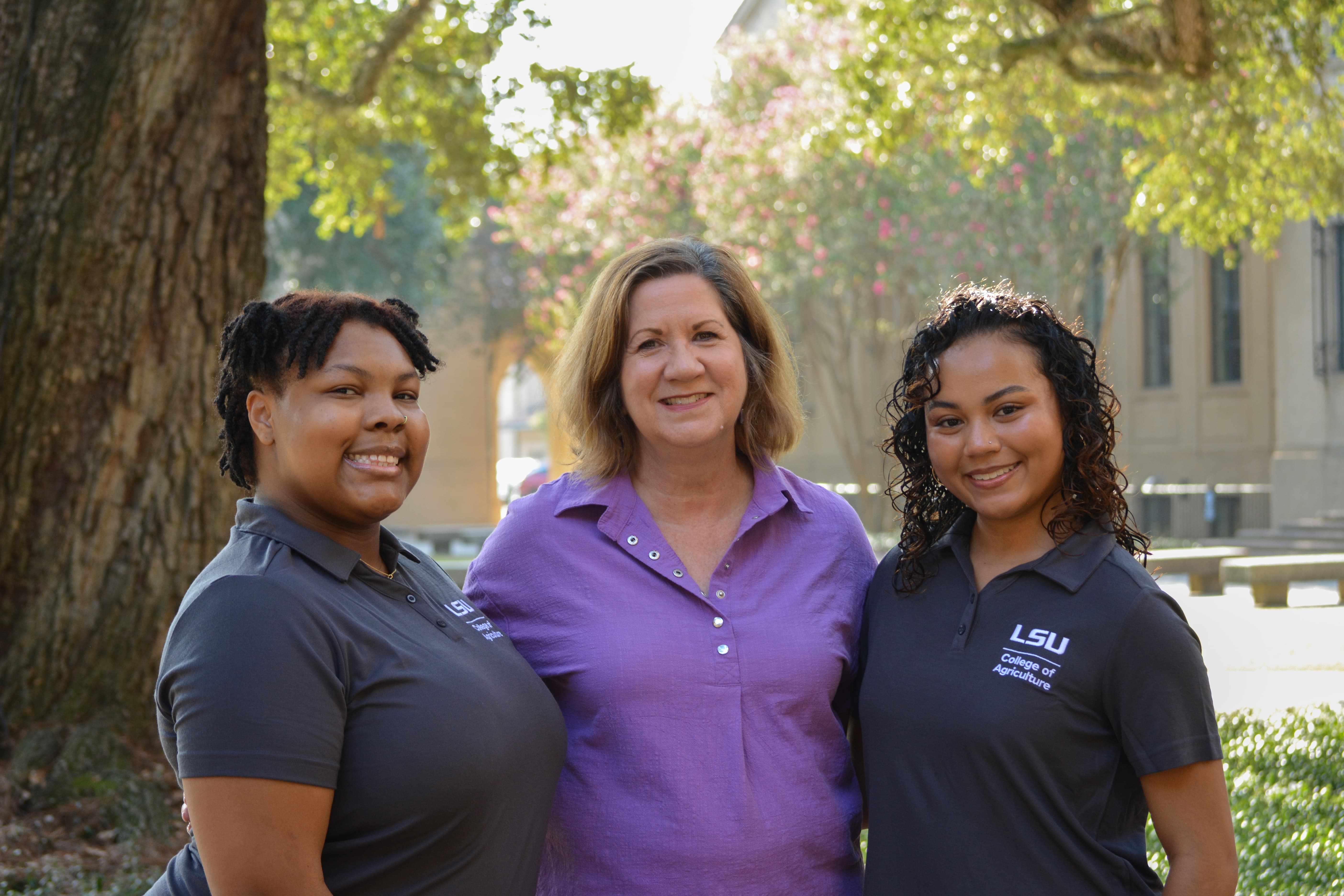 Donna Sapp stands with peer mentors, Erica Landrum and Siana Barker