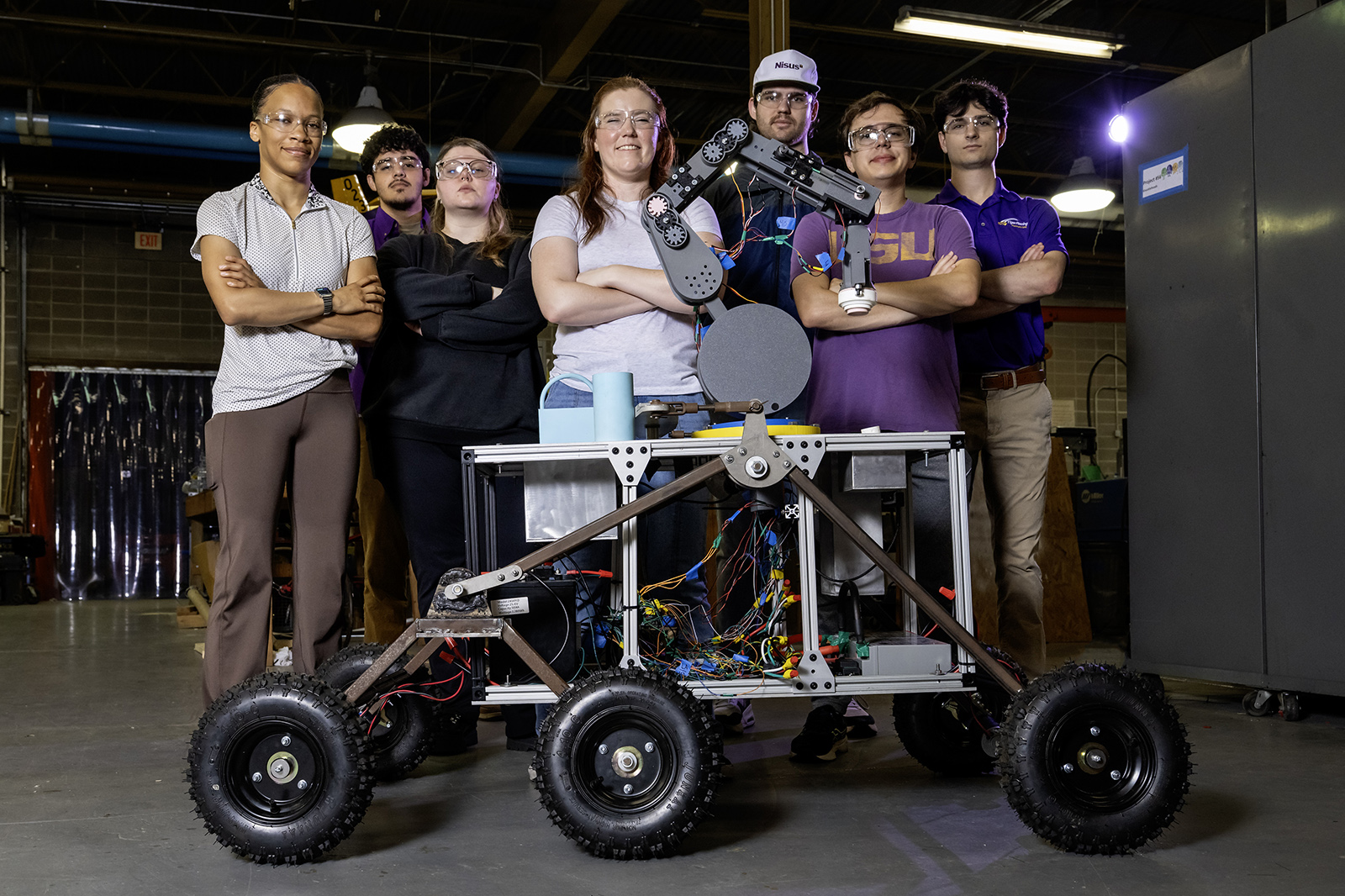 Team members pose with rover