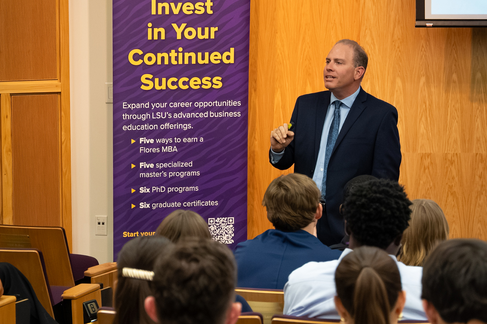 An LSU instructor speaks in front of a large classroom of students