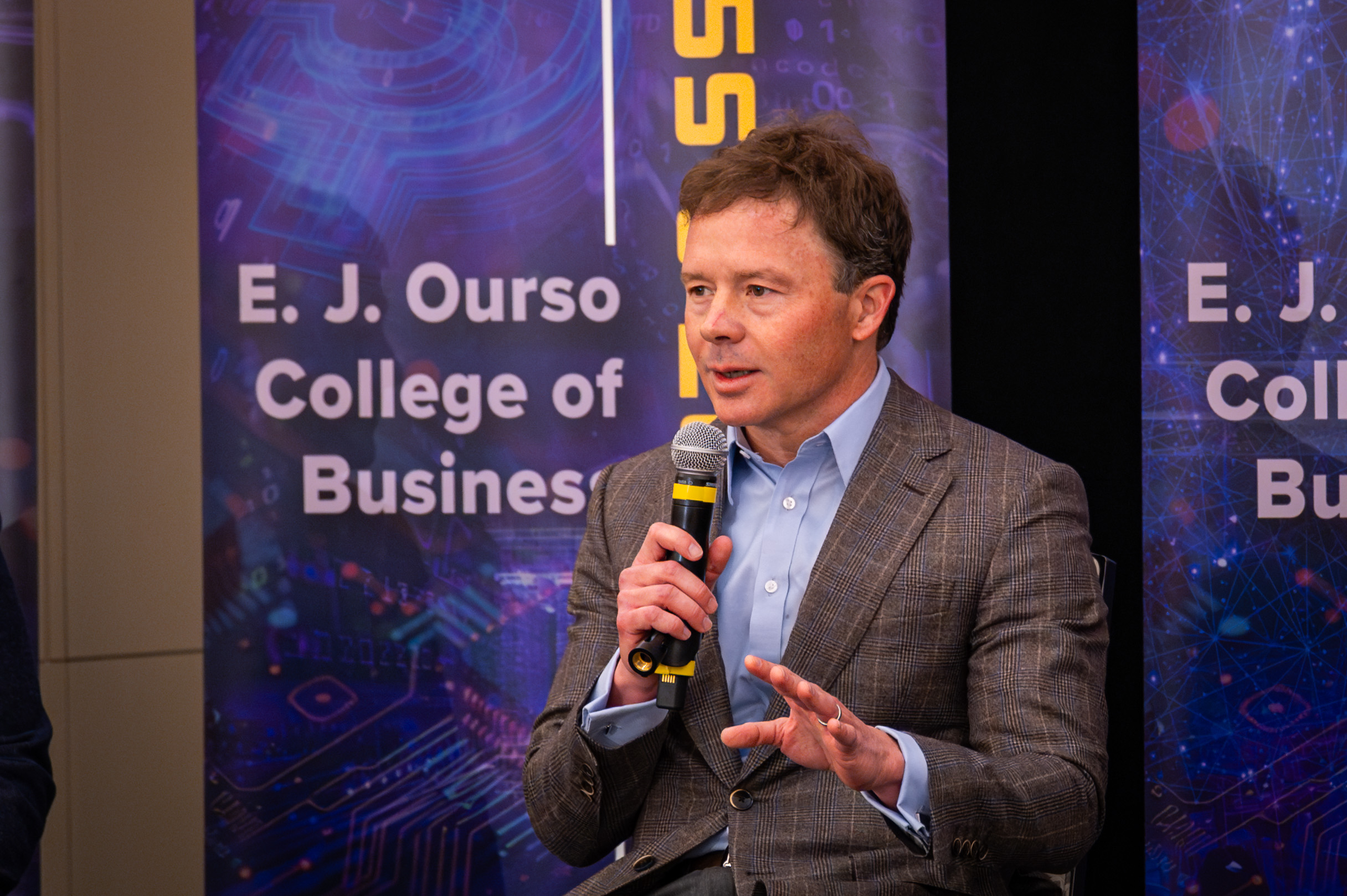 Jude Melville speaking at the AI in Action Symposium.