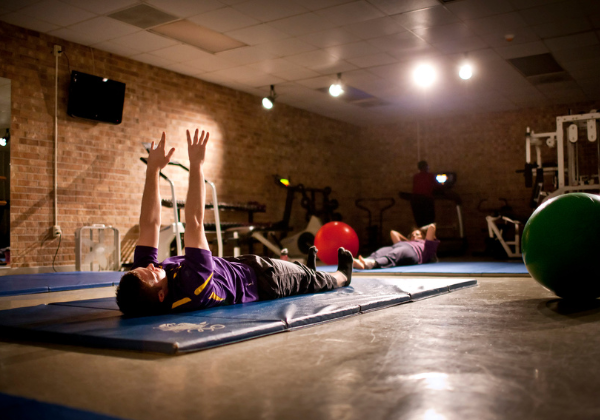 person on ground doing yoga, arms up