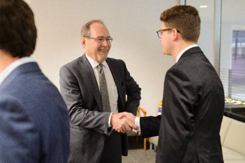 two men in suits shaking hands