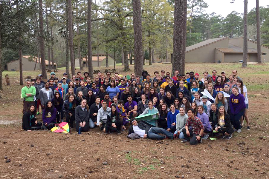 Large group of people posing in the woods