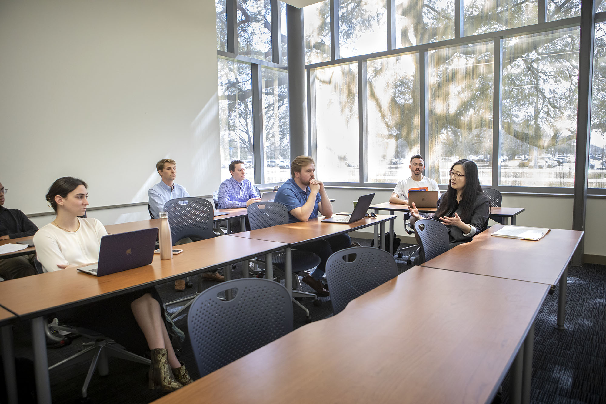 professor talking with business class