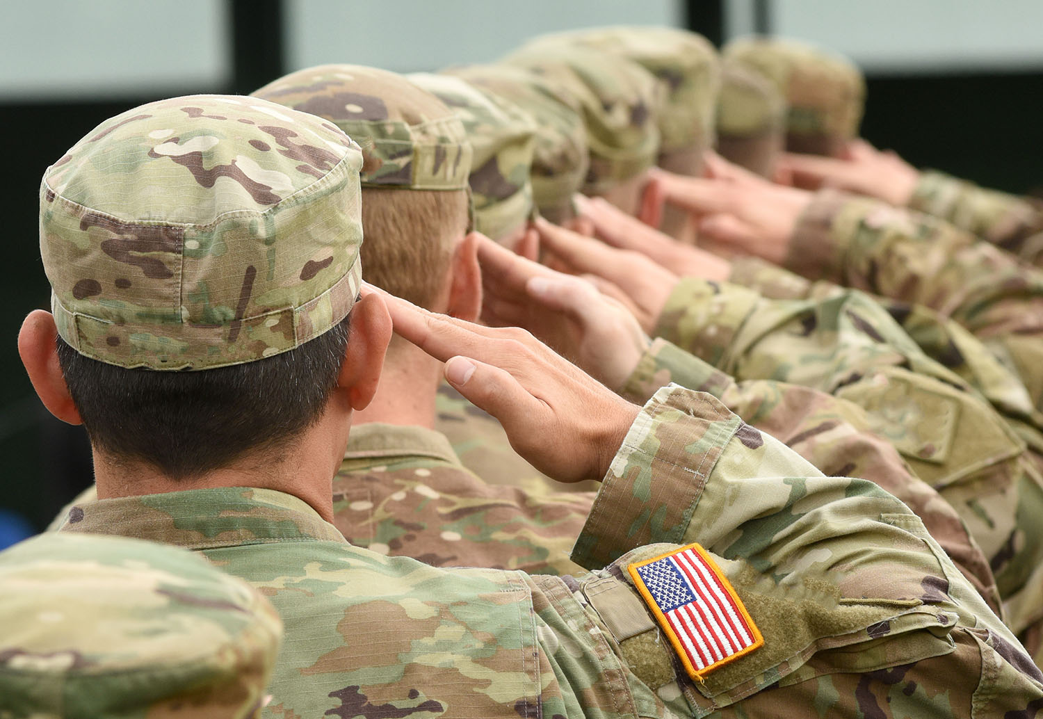 soldiers in uniform soluting