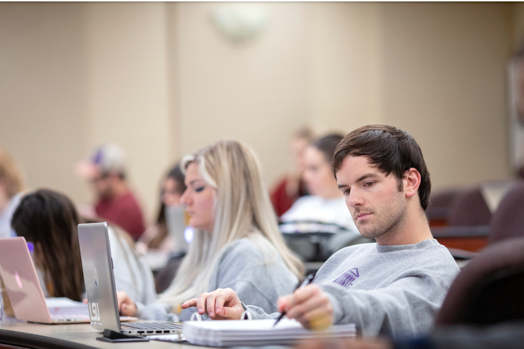 students in class taking notes