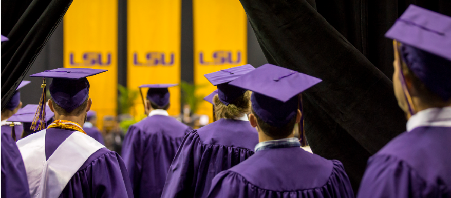 students in cap and gowns at commencement